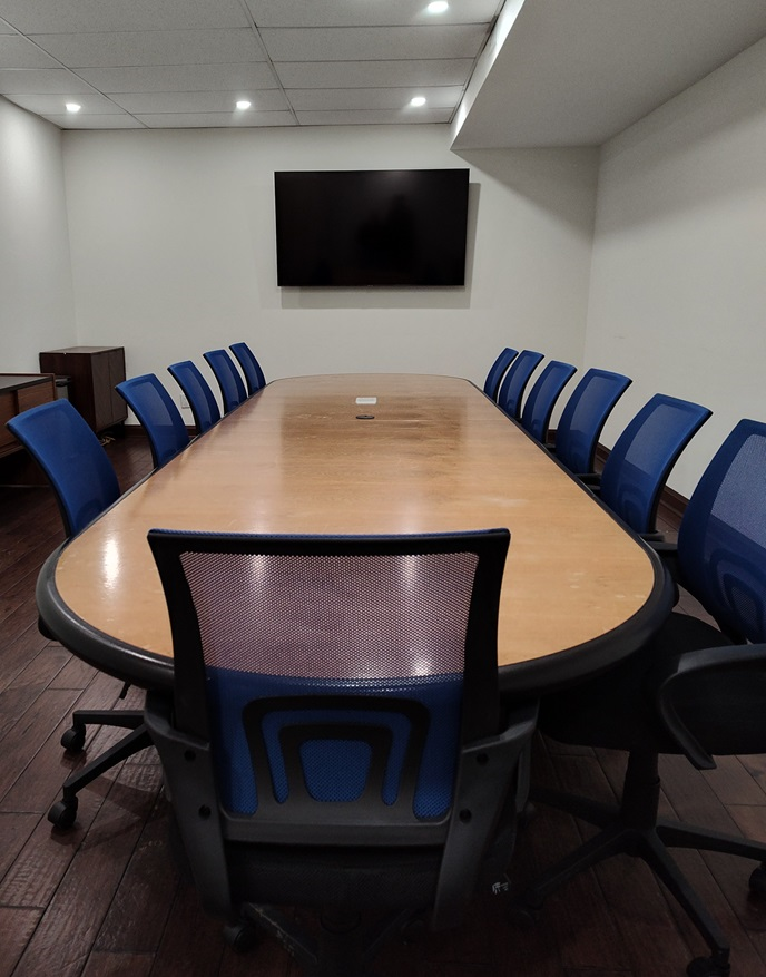 Conference Room table with media center and 70 inch TV wall mounted